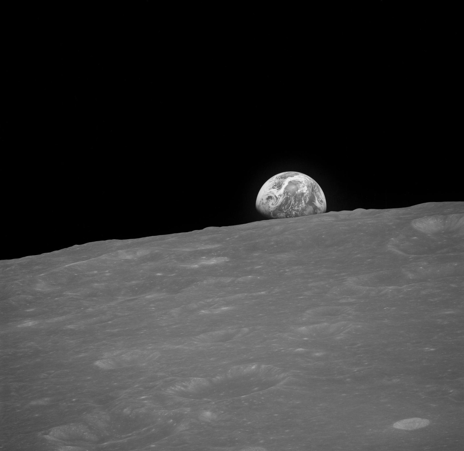 AS08-13-2329 — первый, чёрно-белый кадр восходящей Земли, сделанный чуть раньше.